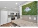 Contemporary kitchen featuring white cabinetry, granite countertops, and stainless steel appliances at 502 Timber Bay E Cir, Oldsmar, FL 34677