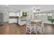 Open kitchen and dining area with updated countertops, stainless steel appliances, and ample natural light at 502 Timber Bay E Cir, Oldsmar, FL 34677