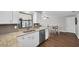 Updated kitchen with white cabinets, granite countertops, and stainless steel dishwasher at 502 Timber Bay E Cir, Oldsmar, FL 34677