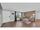 Bright living room with hardwood floors, a large sectional sofa, and modern accents at 502 Timber Bay E Cir, Oldsmar, FL 34677