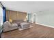 A spacious living room featuring a comfortable gray sectional with modern flooring at 502 Timber Bay E Cir, Oldsmar, FL 34677