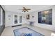Bright sunroom with tile flooring, a modern ceiling fan, and a large window for natural light at 502 Timber Bay E Cir, Oldsmar, FL 34677