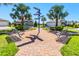 Charming community area with benches and lush landscaping, perfect for relaxation at 5090 Caravel Pt, Land O Lakes, FL 34638
