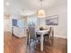Bright dining area featuring wood floors, a modern light fixture, and white shiplap accent wall at 5090 Caravel Pt, Land O Lakes, FL 34638