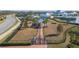 Aerial view of fenced dog park with covered area and a walking path in a Primary planned community at 5090 Caravel Pt, Land O Lakes, FL 34638