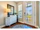 Bright foyer featuring a stylish console table, mirror, and decorative accents at 5090 Caravel Pt, Land O Lakes, FL 34638