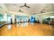 Bright gym with hardwood floors featuring fitness equipment and ample room for activities at 5090 Caravel Pt, Land O Lakes, FL 34638