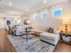 Open concept living room with an adjacent dining area and view of the backyard at 5090 Caravel Pt, Land O Lakes, FL 34638