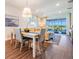 Inviting living space with wood floors, and sliding glass doors leading to the outdoor pool area at 5090 Caravel Pt, Land O Lakes, FL 34638