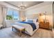 Serene main bedroom with a large window and chandelier at 5090 Caravel Pt, Land O Lakes, FL 34638
