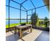 Screened patio featuring a dining set and view of the lake at 5090 Caravel Pt, Land O Lakes, FL 34638
