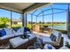Inviting screened patio with comfortable seating and view of the water at 5090 Caravel Pt, Land O Lakes, FL 34638