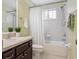 Well-lit bathroom features a shower and tub combination with a window for natural light at 542 Harbor Ridge Dr, Palm Harbor, FL 34683