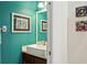 Stylish powder room with vessel sink, modern fixtures, and teal accent wall at 542 Harbor Ridge Dr, Palm Harbor, FL 34683