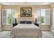 Comfortable bedroom with carpet, shutters and artwork at 542 Harbor Ridge Dr, Palm Harbor, FL 34683