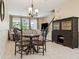 Inviting dining area with a wooden table, stylish hutch, and large windows bringing the outdoors in at 542 Harbor Ridge Dr, Palm Harbor, FL 34683