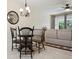 Dining area with a wooden table set, decorative chandelier, and view into the main living area at 542 Harbor Ridge Dr, Palm Harbor, FL 34683