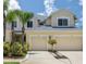 Inviting exterior featuring dual garages, manicured landscaping, and a well-maintained driveway at 542 Harbor Ridge Dr, Palm Harbor, FL 34683