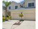 Inviting exterior featuring dual garages, manicured landscaping, and a well-maintained driveway at 542 Harbor Ridge Dr, Palm Harbor, FL 34683