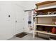 Garage interior featuring a utility door, shelving and equipment storage space at 542 Harbor Ridge Dr, Palm Harbor, FL 34683