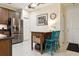 Eat-in kitchen with stainless steel refrigerator, breakfast bar, and modern finishes at 542 Harbor Ridge Dr, Palm Harbor, FL 34683