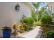 Lush tropical landscaping adorns the front walk to the home at 542 Harbor Ridge Dr, Palm Harbor, FL 34683