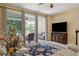 Open living area with sliding glass doors to screened patio, plus a TV and decorative rug at 542 Harbor Ridge Dr, Palm Harbor, FL 34683