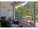 Relaxing screened-in patio overlooking lush greenery and a serene pond at 542 Harbor Ridge Dr, Palm Harbor, FL 34683