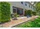 Screened in patio with beautiful landscaping, decorative flowers, and brick pavers at 542 Harbor Ridge Dr, Palm Harbor, FL 34683