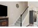 Carpeted staircase leads to the upper level, with adjacent TV and furniture at 542 Harbor Ridge Dr, Palm Harbor, FL 34683