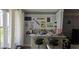 Home bar area with a variety of liquors and nautical-themed decorations near the window at 5501 80Th N St # 207, St Petersburg, FL 33709