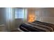 Calm bedroom with large window and tasteful modern decor to create a serene atmosphere at 5501 80Th N St # 207, St Petersburg, FL 33709