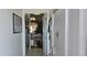 Hallway with a view into a dining area, featuring a hanging light fixture and tiled floors at 5501 80Th N St # 207, St Petersburg, FL 33709