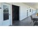 Condominium hallway featuring a staircase, multiple doors, and outdoor seating area at 5501 80Th N St # 207, St Petersburg, FL 33709