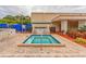 Relaxing hot tub area with brick paving, seating, and beautiful landscaping for a serene outdoor experience at 5501 80Th N St # 207, St Petersburg, FL 33709