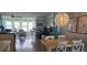 Bright living room with large windows, hardwood floors, and casual seating around a dining table at 5501 80Th N St # 207, St Petersburg, FL 33709