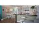 Open-concept living area with a bar, dining table, and view into the kitchen with tiled backsplash at 5501 80Th N St # 207, St Petersburg, FL 33709