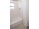 Clean bathroom featuring a tub with shower, tiled walls, and a built-in niche at 5608 Larimer Dr, Tampa, FL 33615