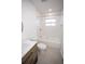 Bathroom featuring a vanity, toilet, and tub with shower, illuminated by natural light at 5608 Larimer Dr, Tampa, FL 33615