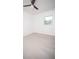 Bedroom featuring a ceiling fan, a window, and a light neutral tile floor at 5608 Larimer Dr, Tampa, FL 33615