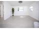Spacious bedroom with light tile flooring, plenty of natural light and neutral paint at 5608 Larimer Dr, Tampa, FL 33615