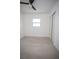 A minimalist bedroom with a ceiling fan and natural light from the window at 5608 Larimer Dr, Tampa, FL 33615