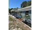 Exterior view of the home highlighting the covered carport, blue brick accents, and front yard at 5608 Larimer Dr, Tampa, FL 33615