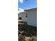 View of the exterior of the home with white stucco and a well-maintained lawn at 5608 Larimer Dr, Tampa, FL 33615