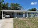 Charming single-story home with a covered carport, blue brick accents, and a well-manicured front yard at 5608 Larimer Dr, Tampa, FL 33615