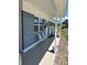 Charming front porch area with two decorative chairs, blue brick and white columns at 5608 Larimer Dr, Tampa, FL 33615