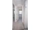 Hallway view to bright bedroom with tile flooring, white walls, and closet at 5608 Larimer Dr, Tampa, FL 33615
