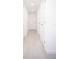 Hallway with multiple doors and white walls, and light neutral tile floor at 5608 Larimer Dr, Tampa, FL 33615