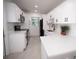 Modern kitchen featuring white cabinets, quartz countertops, black hardware, and stainless steel appliances at 5608 Larimer Dr, Tampa, FL 33615