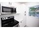 Modern kitchen featuring stainless steel appliances, white cabinets and light countertops at 5608 Larimer Dr, Tampa, FL 33615